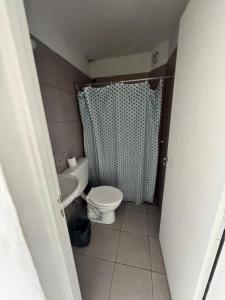 a small bathroom with a toilet and a shower at Condominio Diamante in San Rafael +9 photos