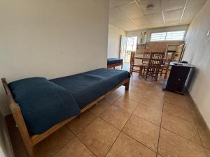a room with a bed and a table and chairs at Condominio Diamante in San Rafael