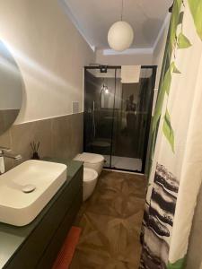 a bathroom with a sink and a toilet and a shower at La casa al mare in Palermo +17 photos