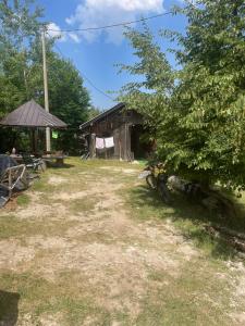 a house with a bike parked in front of it at Sopotnica - Apartman na vodopadima in Prijepolje