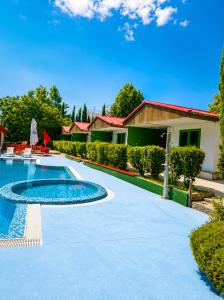 a swimming pool in front of a house at Hotel Jasmine in Byala