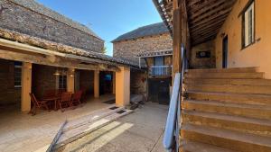 an outdoor patio with stairs and a table and chairs at Les Vieilles Planches in Pampelonne