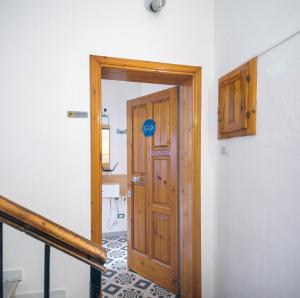 a hallway with a wooden door in a room at Casa iSuLa in Iglesias +10 photos