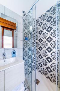 a bathroom with a shower and a sink at Casa iSuLa in Iglesias