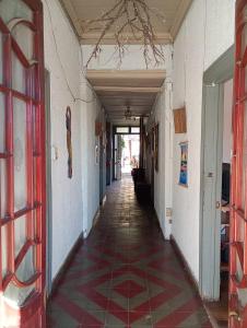 an empty hallway of a building with a tile floor at Hostal Casona del Canto in Los Andes +2 photos