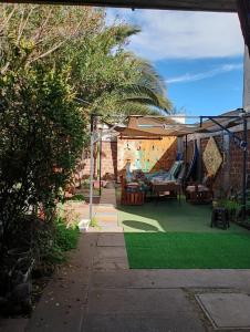 a backyard with a green lawn and a playground at Hostal Casona del Canto in Los Andes