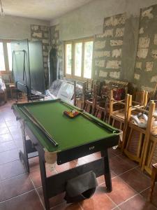 a pool table in a room with chairs at Sopotnica - Apartman na vodopadima in Prijepolje