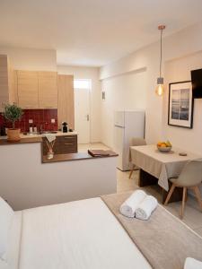 a kitchen and a living room with a bed and a table at Studio Beleri in Himare