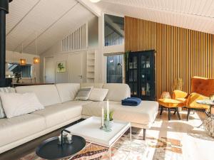a living room with a couch and a table at 5 star holiday home in Bindslev in Bindslev