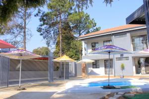 a group of umbrellas in front of a house at Viva Guest House in Trevallyn