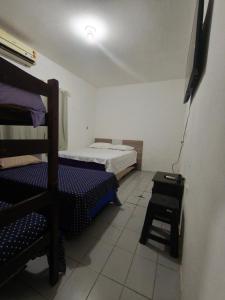 a small room with two bunk beds and a table at Pousada Bom Jesuss in Juazeiro do Norte +1 photo