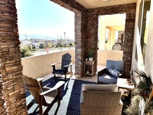 a patio with chairs and a couch on a balcony at Valencia Resort in Santa Clarita +5 photos