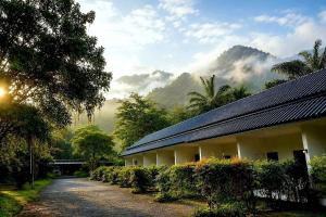 a building with solar panels on it with a mountain at 169 Home Resort in Ban Huai Khram