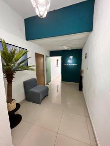 a hallway with a chair and a plant in a room at Adarax Playa Hermosa in Cancún +22 photos