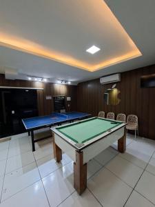 a room with two ping pong tables and chairs at Hotel e Pousada REQUINTTE in Parnaíba