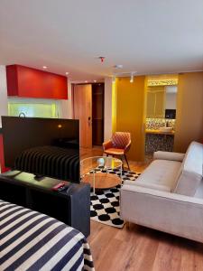 a living room with a couch and a table at Hotel Oliver in Bogotá