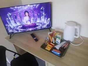 a desk with a tv and a lamp on a table at Connies Retreat in Gold Coast
