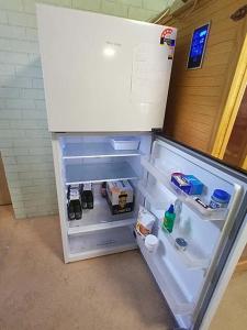 a refrigerator with its door open in a room at Connies Retreat in Gold Coast
