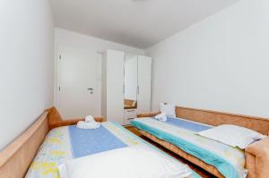 two beds in a small room with at House Ivana in Vinišće +28 photos