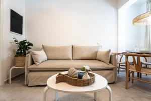 a living room with a couch and a table at Terraegea Paros in Dhragoulás
