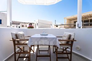 a table and chairs sitting on a balcony at Terraegea Paros in Dhragoulás