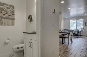 a white bathroom with a toilet and a dining room at Long Stays Welcome! Pet Friendly & Heated Pool in Washington