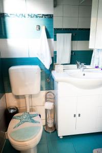 a bathroom with a toilet and a sink at Villa Aki in Posedarje +40 photos