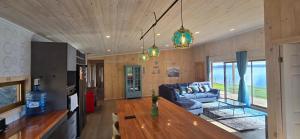 a kitchen and living room with a couch and a table at Casa primera linea de playa in Maricó