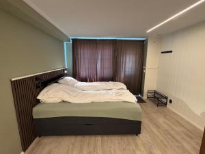 a large bed in a room with a window at Cozy mini-apartment with kitchen in Åmot