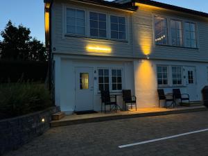 a group of chairs sitting outside of a house at Cozy mini-apartment with kitchen in Åmot