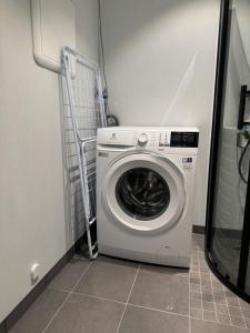 a washer and dryer in a small room at Cozy mini-apartment with kitchen in Åmot