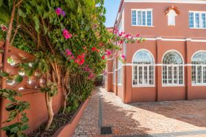 a street in front of a building with pink flowers at Vila Olivença in Costa da Caparica +112 photos