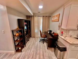 a room with a desk and a computer in a room at The Elegant Suite - 2BR with Great Amenities in Paterson +23 photos