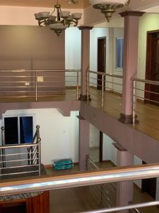 an empty room with a staircase and pillars in a building at Abronoma Guest House in Ogbojo