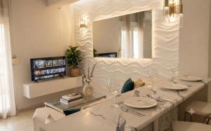 a living room with a table and a mirror at Boutique lux apartments in Kavála