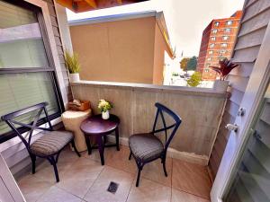 two chairs and a table on a balcony at The Elegant Suite - 2BR with Great Amenities in Paterson