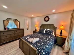 a bedroom with a bed and a clock on the wall at The Elegant Suite - 2BR with Great Amenities in Paterson
