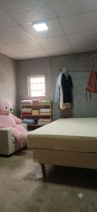 a bedroom with two beds and a pink stuffed animal at La parada de Emma in Las Lomas