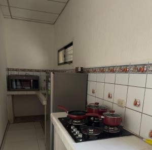a kitchen with pots and pans on a stove at Apartamento comodo en Rivas in Rivas +5 photos