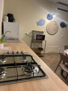 a kitchen with a stove and a counter top at La casa al mare in Palermo