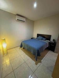 a bedroom with a bed and a air conditioner at Departamento #5 in San Carlos