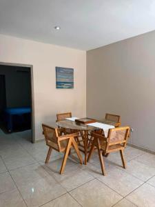 a dining room with a table and chairs and a tv at Departamento #5 in San Carlos