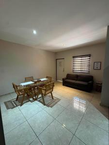 a living room with a table and a couch at Departamento #5 in San Carlos