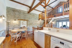 a kitchen and dining room with a table and chairs at 2 Bed in Ambleside oc-lr177 in Ambleside