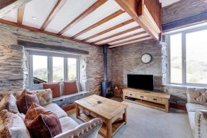 a living room with a couch and a tv at 2 Bed in Ambleside oc-lr177 in Ambleside