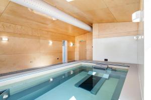 a swimming pool in a room with a wooden ceiling at 2 Bed in Ambleside oc-lr177 in Ambleside
