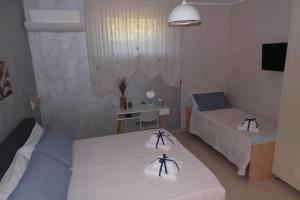 a bedroom with two beds and a table with a desk at La casa di Mazzancollo in San Martino in Pensilis