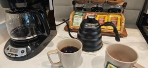 two cups of coffee on a counter next to a blender at Walkable to Parks, Yellowstone River, Coffee Shop in Billings