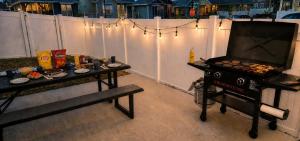 a grill with food on it next to a fence at Walkable to Parks, Yellowstone River, Coffee Shop in Billings