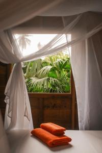 two towels sitting on a table in front of a window at Madre Selva Eco Lodge in Nuquí